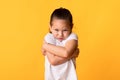 Young sad girl looking at camera with crossed arms Royalty Free Stock Photo