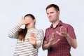 Portrait ofyoung couple looking on something unpleasant gesturing with hands refusing to buy it Royalty Free Stock Photo