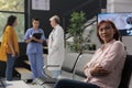 Portrait of old asian patient sitting in hospital waiting area Royalty Free Stock Photo