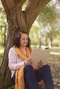 Portrait of old caucasian woman reading a book outdoors Royalty Free Stock Photo