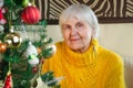 Portrait of old grandmother at home in new year. caucasian positive, friendly granny in festive, white knitted sweater