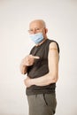 Portrait of an old man with a band-aid on a shoulder isolated on a white background Royalty Free Stock Photo