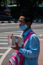 Jakarta, Indonesia - August 26, 2020: Portrait of old man is selling islamic book at the street of Jakarta.