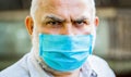 Portrait of an old man, years old, in a medical mask. Concept danger of coronavirus for the elderly. Coronavirus Royalty Free Stock Photo