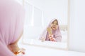 Old muslim woman looking at mirror in the bedroom Royalty Free Stock Photo