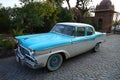 Old retro blue commander vintage car parked at driveway of a house, outdoor natural background, vintage car Royalty Free Stock Photo