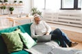 Portrait old senior elderly man with headphone listening to music on laptop at home - active senior people concept Royalty Free Stock Photo