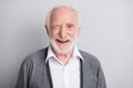 Portrait of old white hair optimistic man blink wear dark sweater isolated on grey background Royalty Free Stock Photo