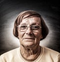 Portrait of old woman in dark background Royalty Free Stock Photo