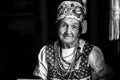 Portrait of old woman in ethnic clothes in her house. Black and white contrast photo. Royalty Free Stock Photo