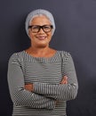 Portrait, old woman and fashion with glasses, arms crossed and happiness on dark studio background. Face, old person and Royalty Free Stock Photo