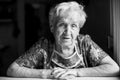 Portrait of old woman in her home. Black-and-white photo. Royalty Free Stock Photo