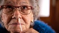 Portrait of old woman taking a self swabbing home tests Covid19 with antigen kit Royalty Free Stock Photo