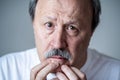 Close up portrait of sad old man face suffering from depression Royalty Free Stock Photo