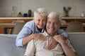 Portrait older wife cuddles husband laughing spend time at home