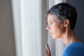 Older woman looking out window Royalty Free Stock Photo