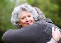 Portrait, older woman or man to hug, love or trust in nature, wellness or bonding together. Senior couple, smile or Royalty Free Stock Photo