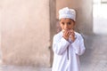 Portrait of an Omani boy in a traditional Omani dress. Nizwa, Oman - 15/OCT/2016