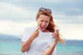 Portrait one angry young woman screaming on mobile phone standing outside with sea  background. Negative emotions feelings Royalty Free Stock Photo