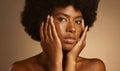 Portrait of one beautiful african american woman with afro posing in a studio and touching her face with her hand Royalty Free Stock Photo