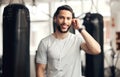 Portrait of one confident young hispanic man listening to music with earphones to stay motivated while exercising in a Royalty Free Stock Photo