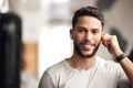 Portrait of one confident young hispanic man listening to music with wireless bluetooth earphones to stay motivated Royalty Free Stock Photo