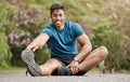 Portrait of one fit young indian man touching his feet and stretching legs for warmup to prevent injury while exercising Royalty Free Stock Photo