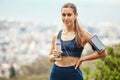 Portrait of one fit young mixed race woman taking a rest break to drink water from bottle while exercising outdoors Royalty Free Stock Photo