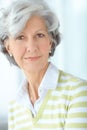 Portrait of one happy senior caucasian woman with grey hair enjoying free time at home. Face of carefree, wise and Royalty Free Stock Photo