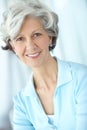 Portrait of one happy senior caucasian woman with grey hair enjoying free time at home. Face of carefree, wise and Royalty Free Stock Photo