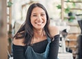 Portrait of one happy young hispanic waitress working in a store or cafe. Friendly woman and coffeeshop owner managing a