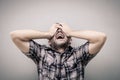 Portrait one sad man standing near a wall and covers his face Royalty Free Stock Photo