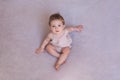 Portrait of a one year old girl, purple background.