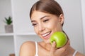 Portrait of open mouthed woman about to bite green apple Royalty Free Stock Photo