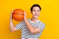 Portrait of optimistic guy with brunet hair wear stylish t-shirt play in university bascketball league isolated on