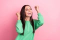 Portrait of optimistic nice person long hairstyle wear green pullover clenching fists celebrate winning isolated on pink Royalty Free Stock Photo