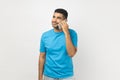 Optimistic man talking on cell phone, having pleased positive expression, enjoying conversation. Royalty Free Stock Photo