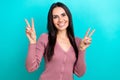 Portrait of optimistic woman long hairstyle dressed pastel clothes showing v-sign symbol isolated on shine turquoise Royalty Free Stock Photo