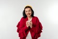 Portrait of optimistic young woman hold cup of coffee wear red sweater  on white background Royalty Free Stock Photo