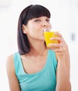 Portrait, orange juice and woman with drink for healthy diet, nutrition and wellness in home. Face, glass and person