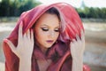 Portrait in Oriental style. Young attractive woman with green eyes, a red scarf on her head. Royalty Free Stock Photo