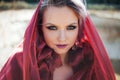 Portrait in Oriental style. Young attractive woman with green eyes, a red scarf on her head. Royalty Free Stock Photo