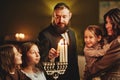 Jewish Man Lighting Menorah Candle