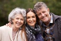 Portrait, outdoor and senior parents with adult daughter, embrace and happy with nature and bonding together. Face Royalty Free Stock Photo