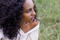 Portrait outdoors of a beautiful young afro american smiling woman at sunset. Green background. Lifestyle. Nature Royalty Free Stock Photo