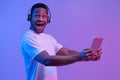 Portrait Of Overjoyed Black Guy in Wireless Headphones With Digital Tablet Royalty Free Stock Photo