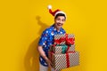 Portrait of overjoyed positive man hands hold pile stack festive giftbox isolated on yellow color background