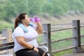 Fat woman drinks water after doing run exercises Royalty Free Stock Photo