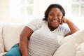 Portrait Of Overweight Woman Sitting On Sofa Royalty Free Stock Photo