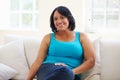 Portrait Of Overweight Woman Sitting On Sofa Royalty Free Stock Photo